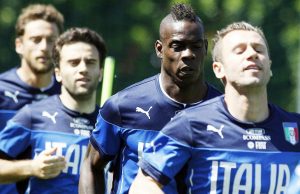 Italy's Mario Balotelli, second from right, warms up with teammates Antonio Cassano, left, Giuseppe Rossi, second from left, and Claudio Marchisio during a training session in Coverciano training complex, in Florence, Italy, Wednesday, May 21, 2014. Police have had to intervene after Mario Balotelli was subjected to racist chants at Italy's World Cup training base. A few kids outside the Coverciano complex were responsible for the chants, and Balotelli appeared visibly disturbed. The training session was open to media and Balotelli could be heard saying as he ran by reporters, "Only in Rome and Florence are they that stupid." While most of the fans cheered for Balotelli, police approached the area where the chants came from and they quickly ended. Balotelli was born in Sicily to Ghanaian immigrants and brought up by an Italian foster family. He has faced racist chants throughout his professional career. (AP Photo/Fabrizio Giovannozzi)