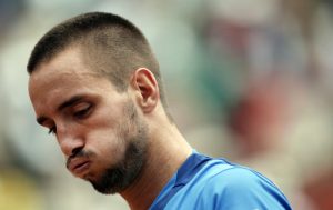 FILE - In this June 2, 2013, file photo, Serbia's Viktor Troicki blows out air as he plays France's Jo-Wilfried Tsonga during their fourth round match of the French Open tennis tournament at the Roland Garros stadium in Paris. Troickis doping ban was reduced from 18 months to 12 on Tuesday, Nov. 5, 2013 although he still cannot play in next week's Davis Cup final. (AP Photo/Christophe Ena, File)