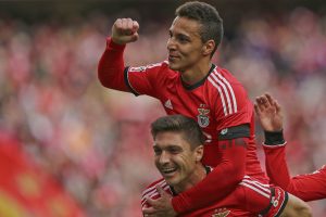 epa04117500 Benfica players Rodrigo Moreno and Guilherme Siqueira (down) celebrate a goal against Estoril Praia during their Portuguese First League match held at Luz Stadium in Lisbon, Portugal, 09 March 2014. EPA/JOSÉ SENA GOULÃO